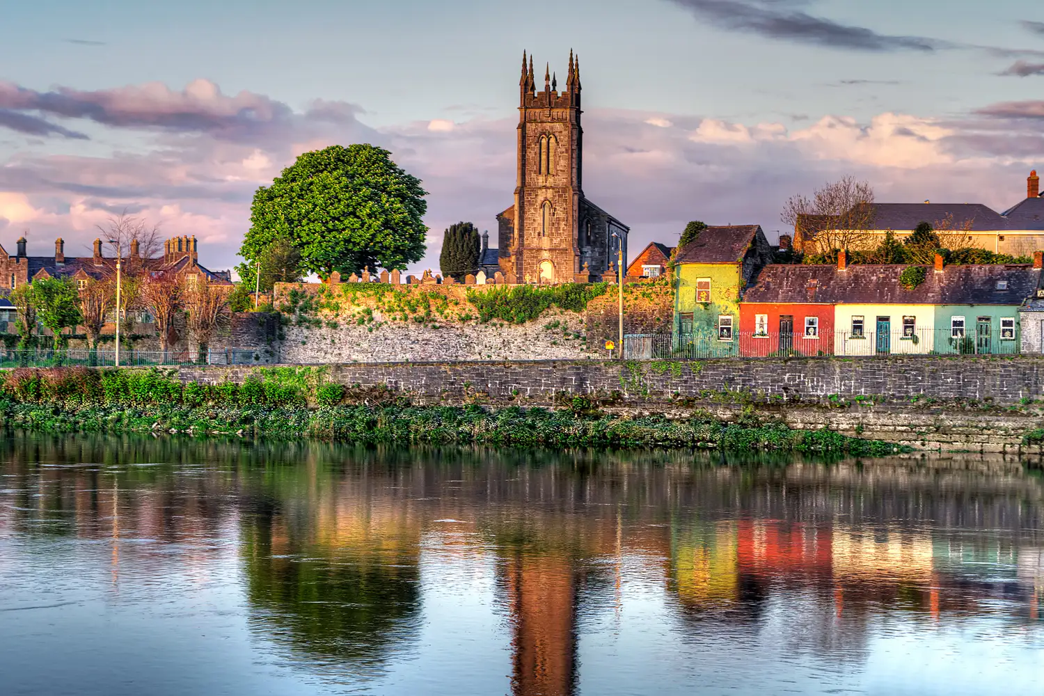 Ireland small town with houses at a river at sunset